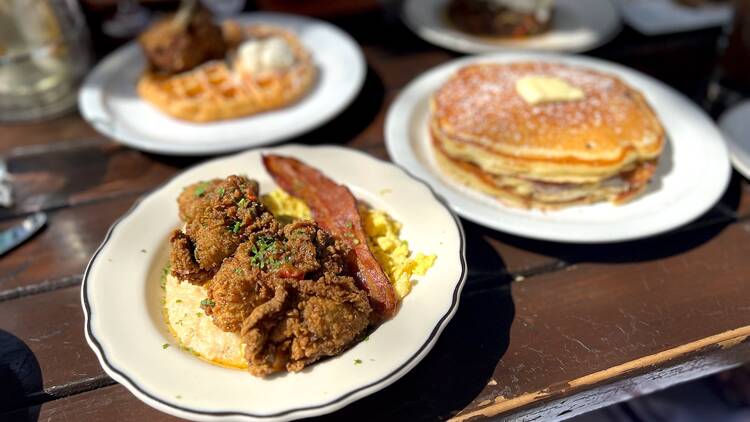 Shrimp and grits with fried oysters, fried chicken and waffle and buttermilk pancakes at Post & Beam