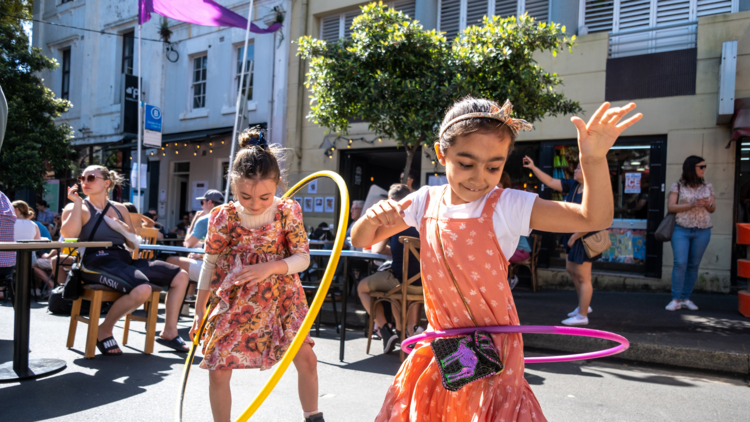 Two kids hola hooping on the street