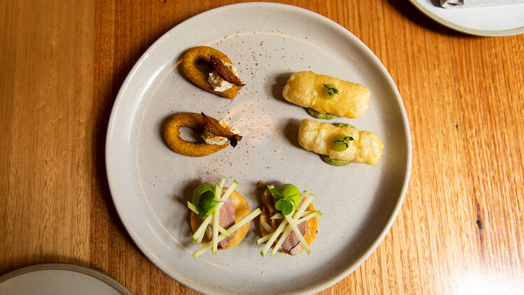 Plate of South American snacks on a wooden table.