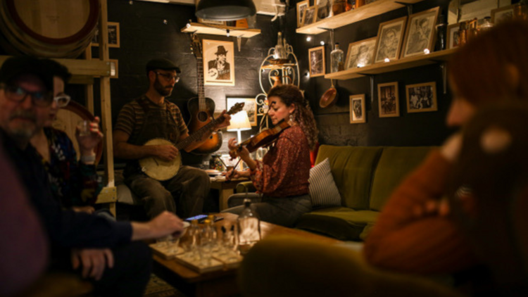 An intimate bar lounge room with musicians 
