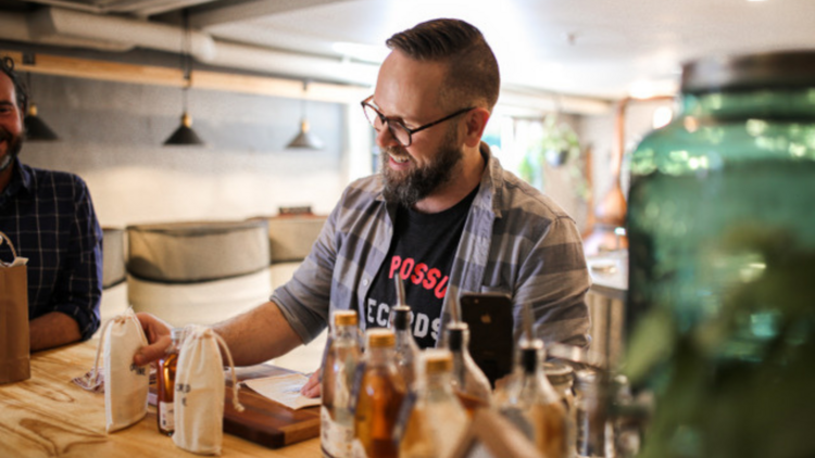 A bartender at a distillery