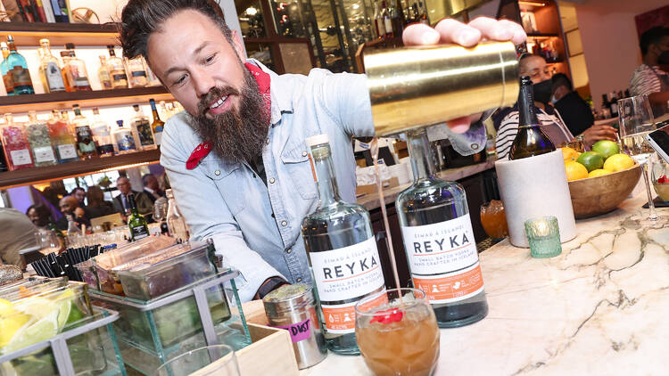 Reyka Vodka’s brand ambassador and mixologist Jeff Naples pours a drink.