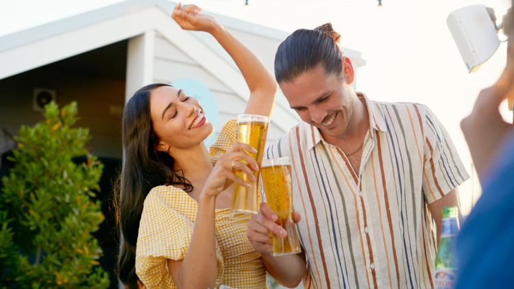 Two people dancing with beers