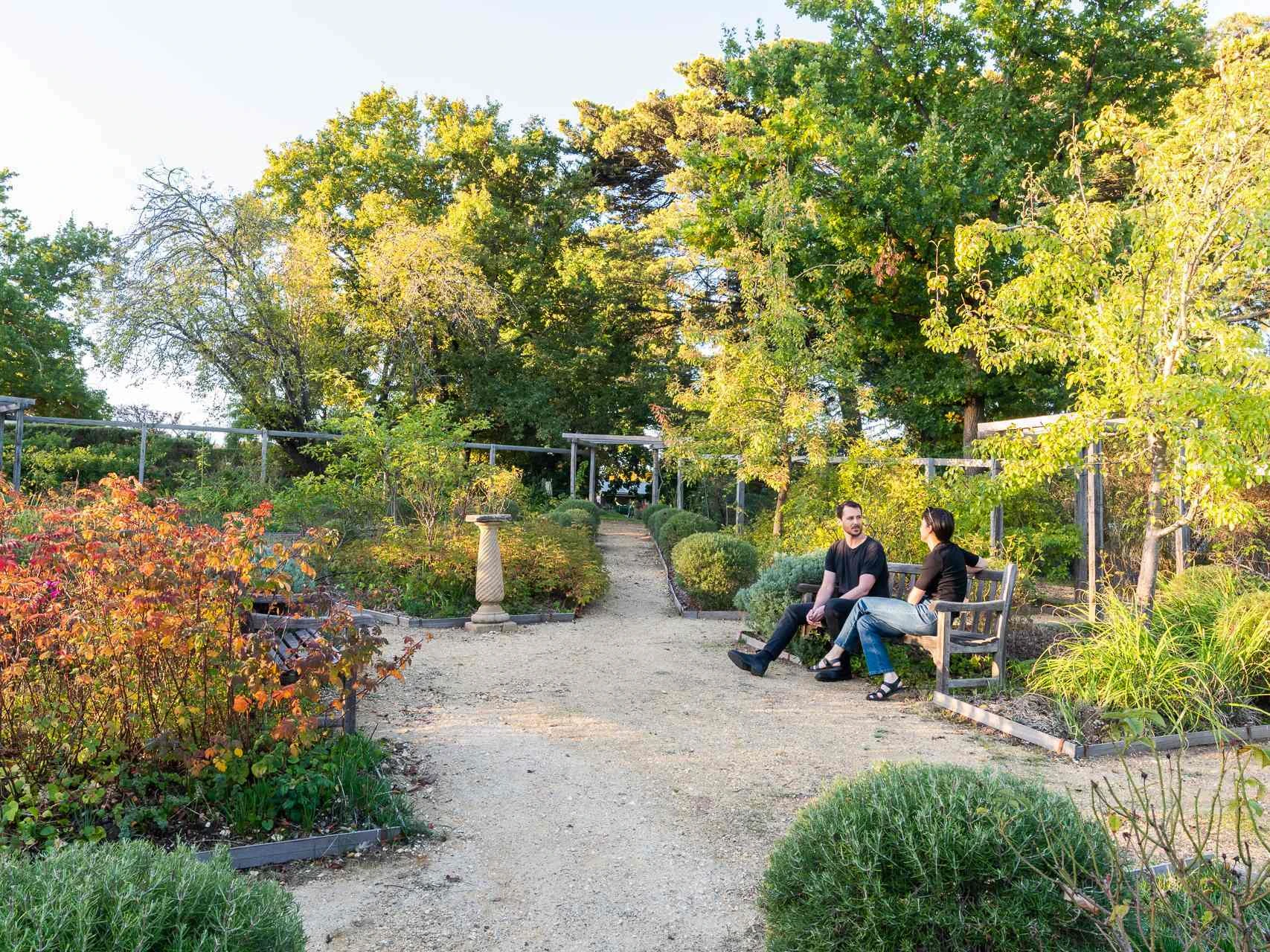 A couple seated in the grounds of Buda House