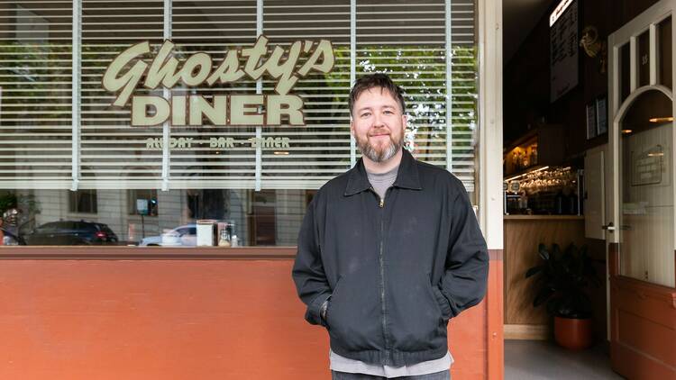 The owner of Ghosty's Diner in front of the restaurant