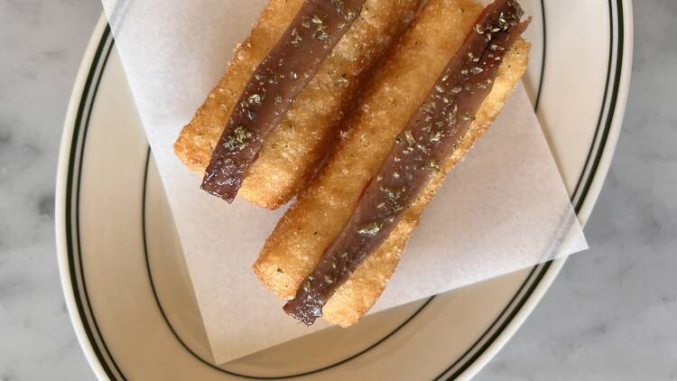 An Italian snack with anchovies on a plate.