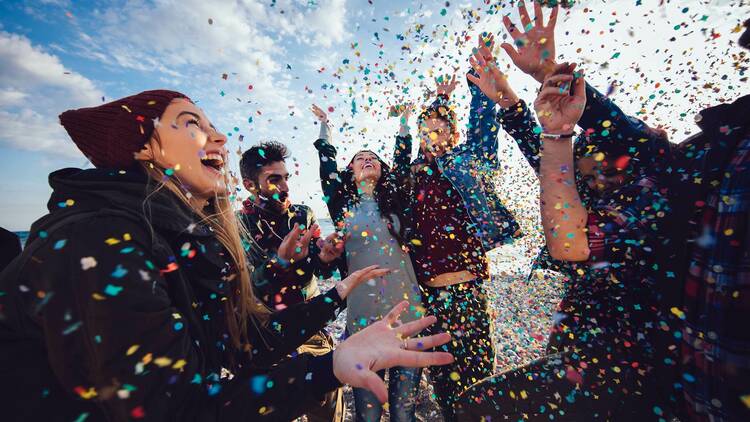 Young people throwing confetti