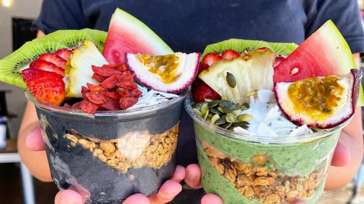 Two smoothie bowls with fresh fruit