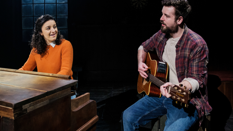 picture of woman playing piano and man playing guitar