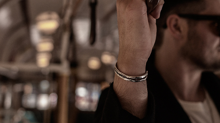 A silver bracelet on a man's wrist.
