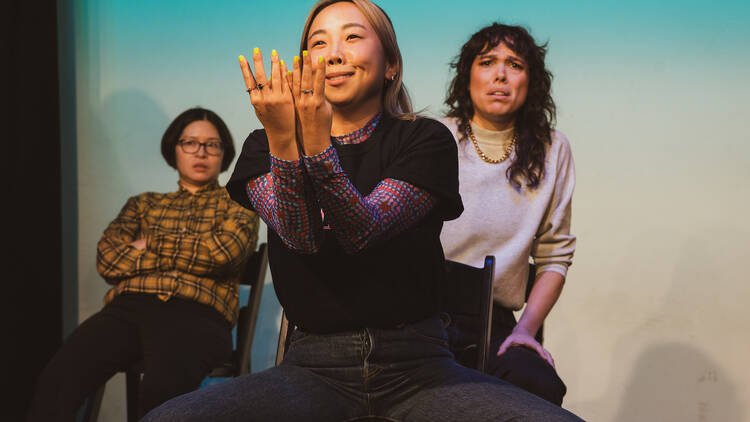 Three performers on a stage.