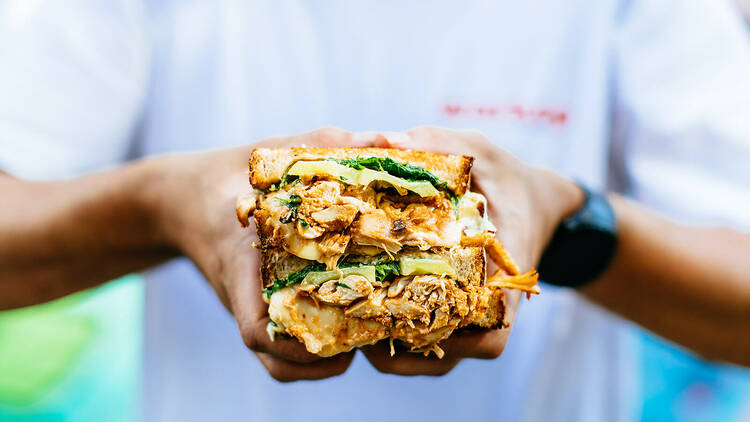 Man holding an Indonesian-style sandwich.