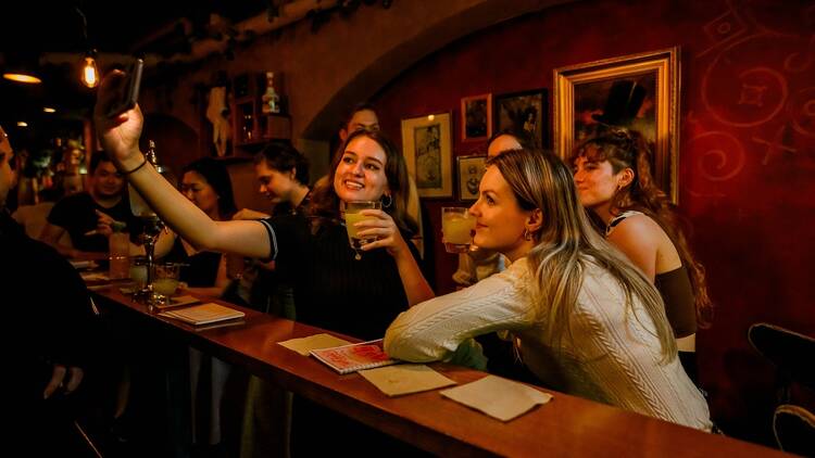 A goup of friends taking a photo and drinking at Papa Gede's