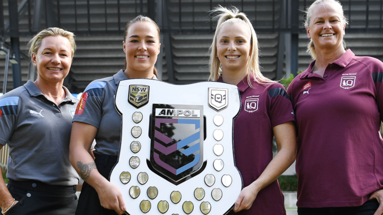 Two NSW Blues representatives and two QLD Maroons representatives holding the Ampol Women's State of Origin plaque.