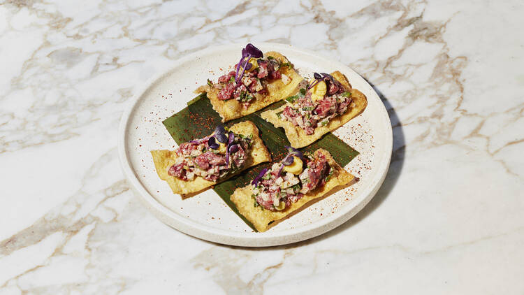 Plate of cracker with toppings.