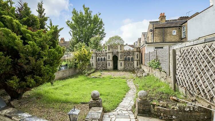 Miniature stone castle in the garden of a house in south London
