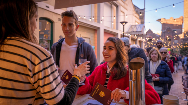 Two people with their wine passports at Bastille Festival