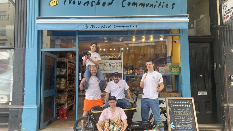 Nourished Communities team standing outside the shop