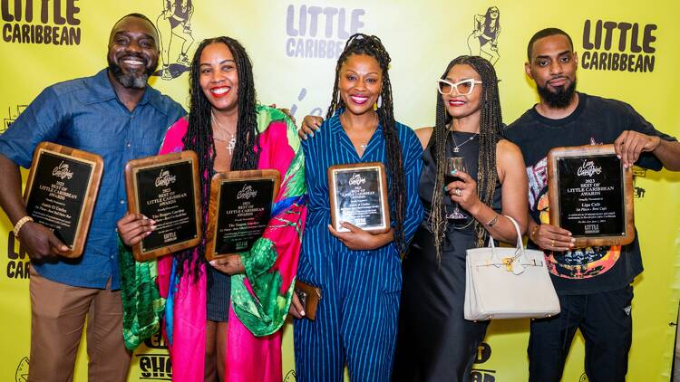 Business owners representing Aunts et Uncles, The Rogers Garden and Lips Cafe, all holding awards.