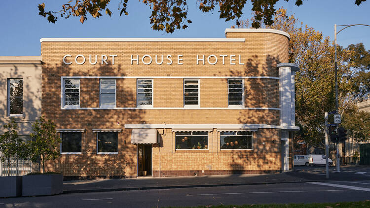 The Courthouse Hotel street view with blue sky in the background.