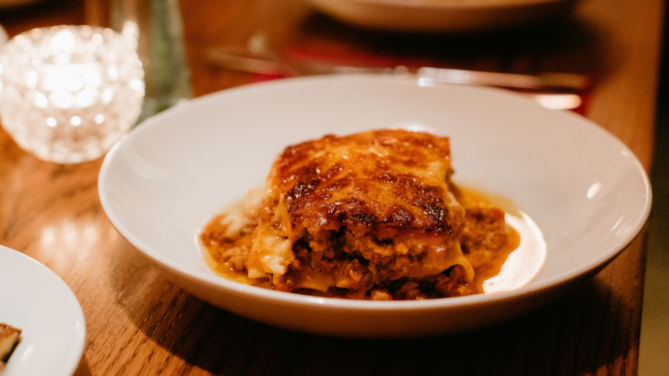 A slab of lasagne on a white plate.