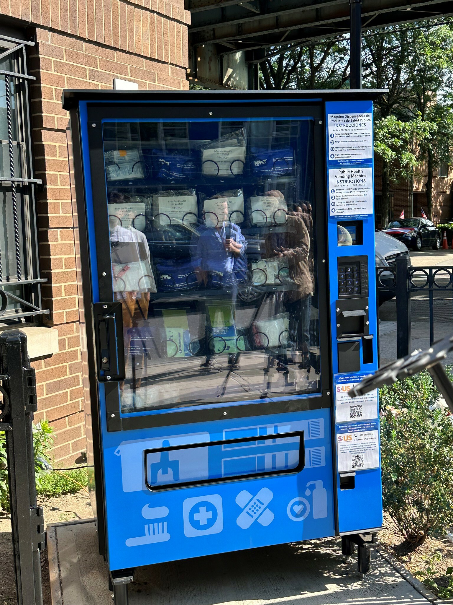 NYC’s first public health vending machine. It’s blue and is standing outside a building.