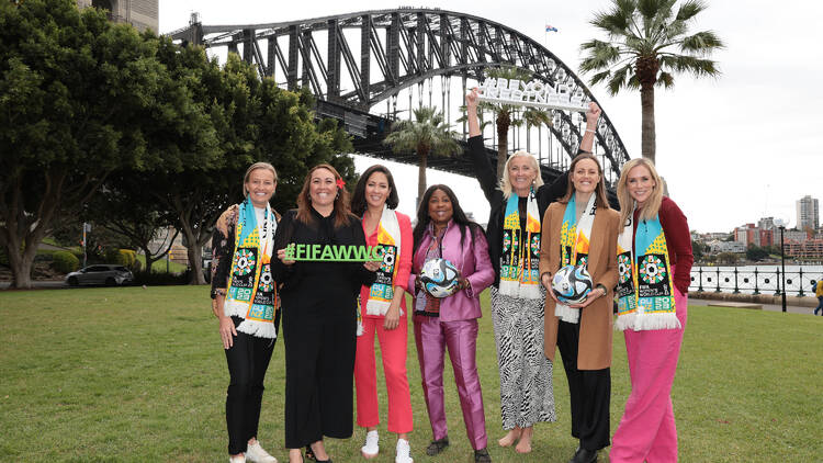 Women standing in front of the Sydney Harbour Bridge.