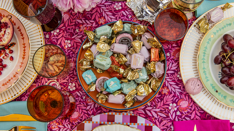 Wrapped chocolates on a colourful table setting.