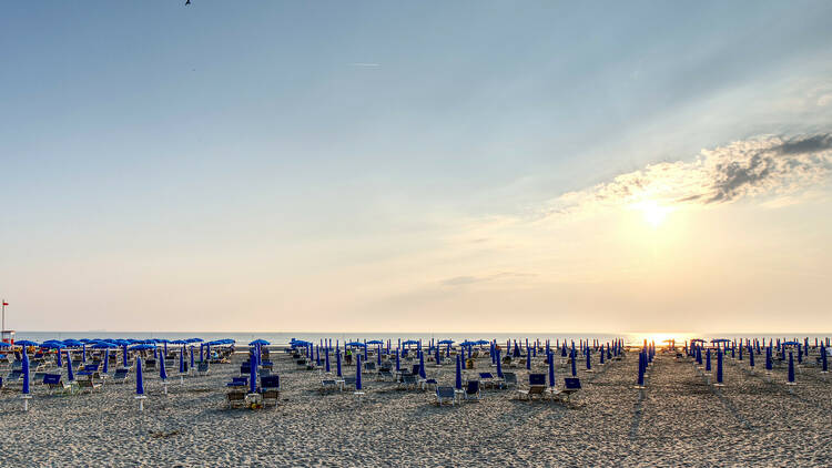 Sun loungers on Abarella Beach at sunset