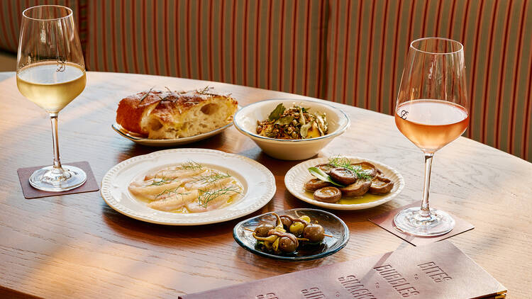 Table with an array of dishes and wines.