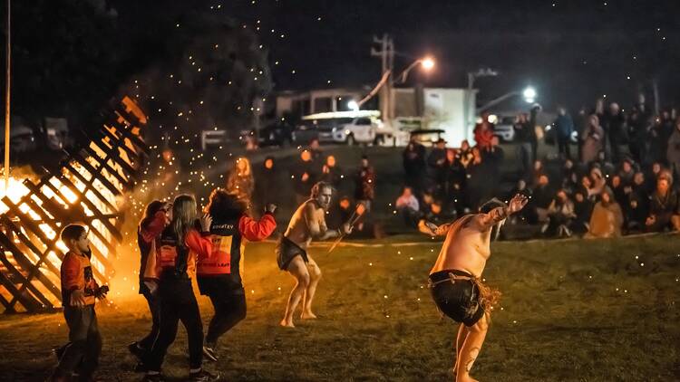 A traditional Indigenous performance at night on the foreshore of Apollo Bay.