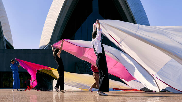 Performers holding silks outside the Opera House