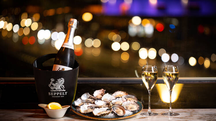 Bottle of champagne and oysters over night views.