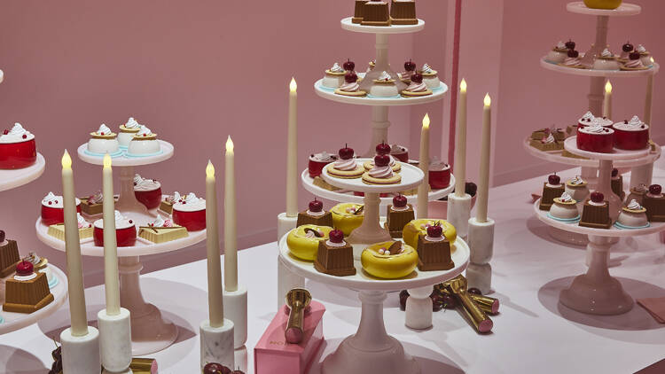 Candles and desserts on a table.