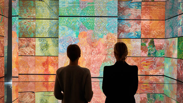 picture of two people looking at a colourful wall ahead of the lume listing