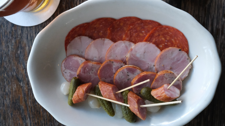 A plate of sliced sausages.