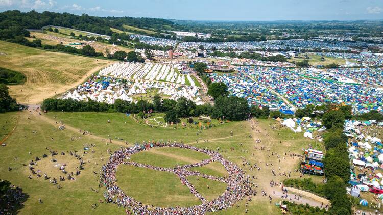 Massive peace sign created by humans at Glastonbury