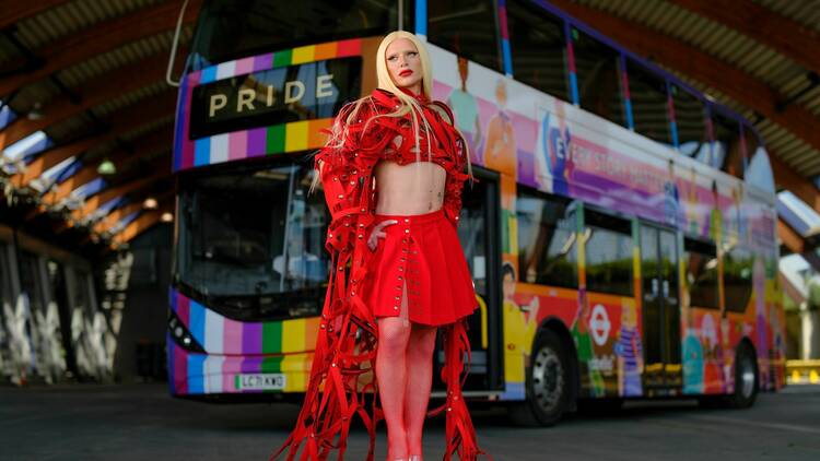 Bimini standing in front of a London Pride bus 
