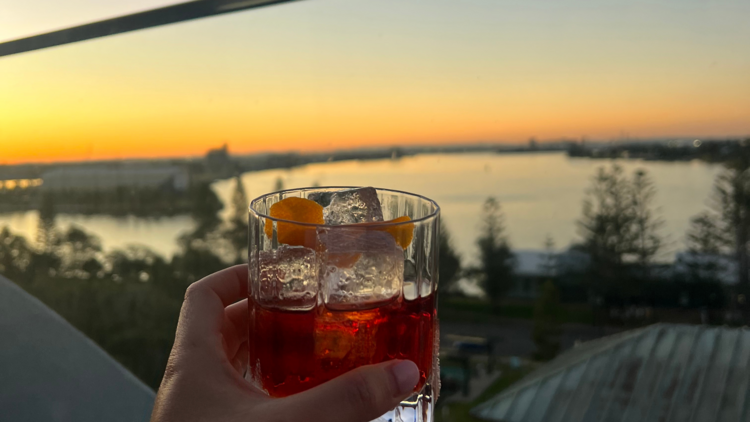 A cocktail at sunset at the QT Newcastle rooftop bar