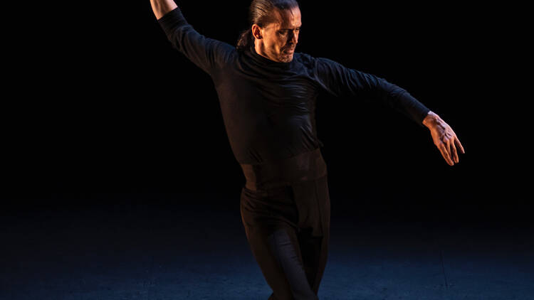 A male flamenco dancer performing in all black 