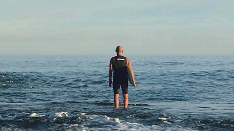 picture of a surfer standing in the sea