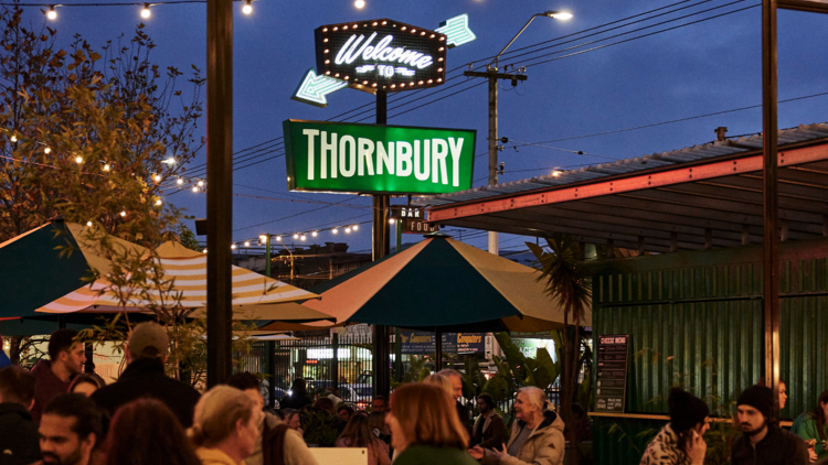image of people sitting down and drinking at welcome to thornbury
