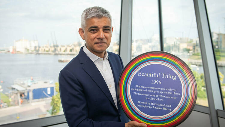 Sadiq Khan holding a rainbow plaque