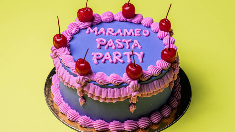 Marameo Pasta Party pink and purple cake with cherries on top.