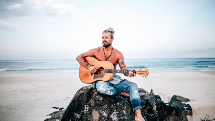 Xavier Rudd on a rock