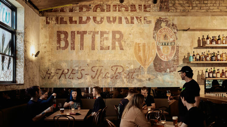 Bar with Melbourne Bitter mural on the wall.