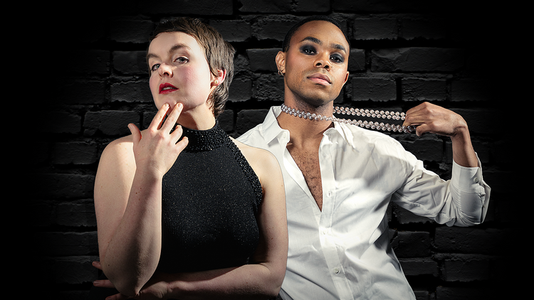 Actors Willow Sizer and Javon King pose in front of a black brick wall.
