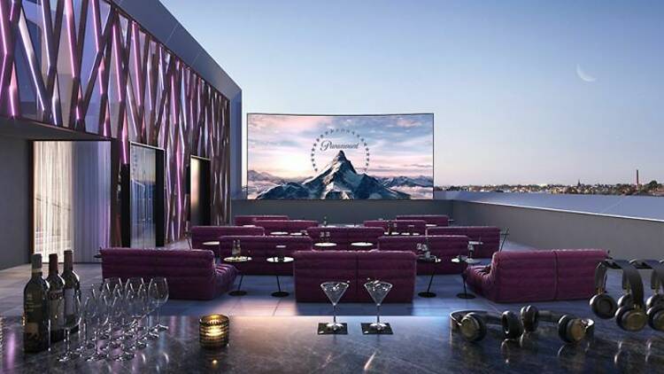 A rooftop cinema with large screen.