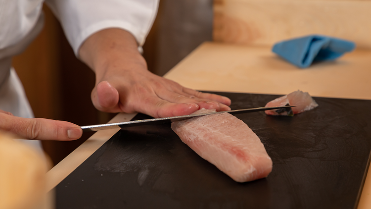 Chef slicing fish upclose (Ishi Park Slope)