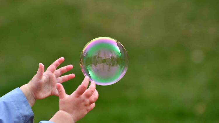 child catching a bubble
